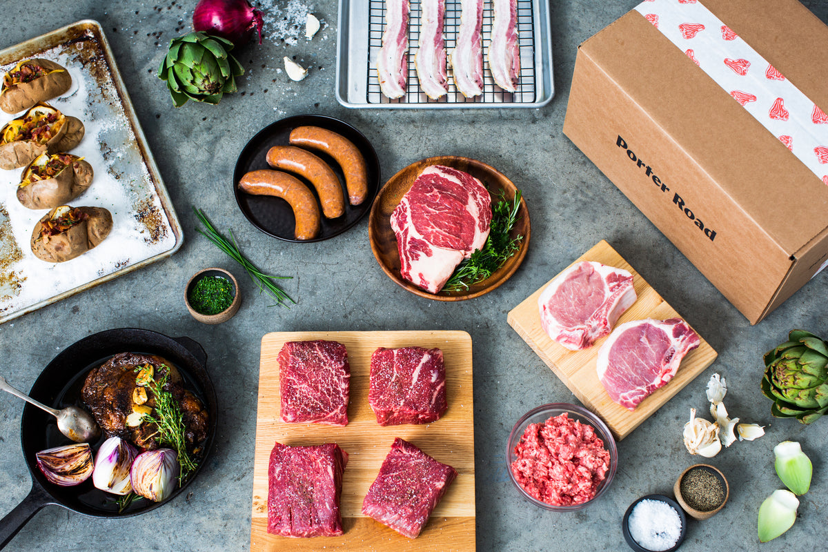 An overhead spread of raw steaks, sausages and other Porter Road cuts ready to pack